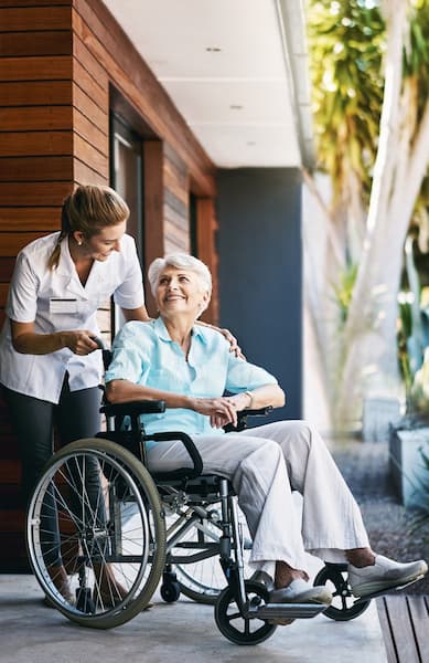 An aged care nurse with a patient on a wheelchair