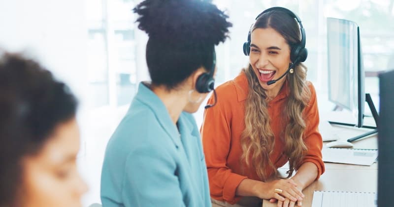 Two customer service female workers smiling
