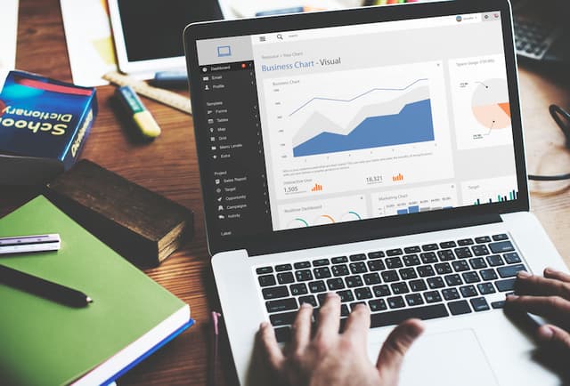A laptop screen with business chart data