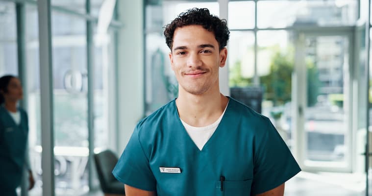 A young male registered nurse smiling