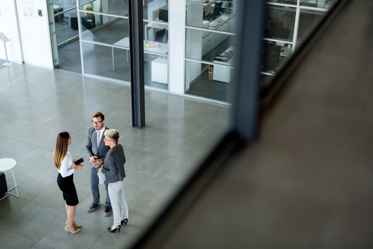 three business people discussing in a modern building