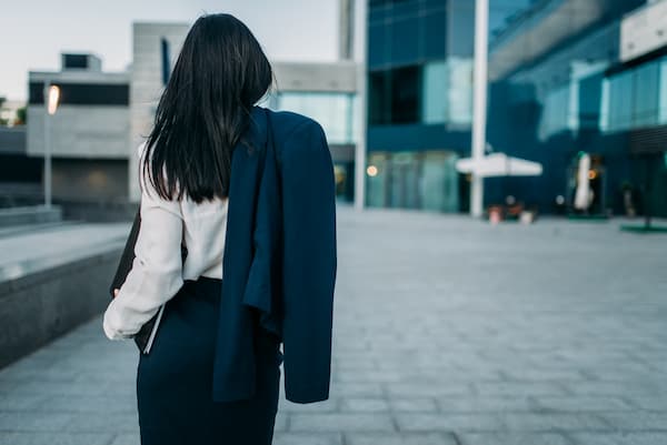 Back view of a business woman around modern business buildings