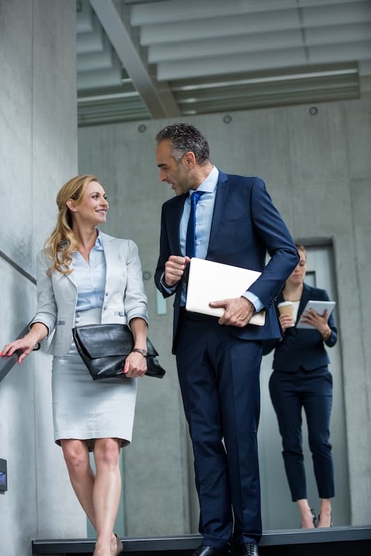 Two business people talking outside a modern building