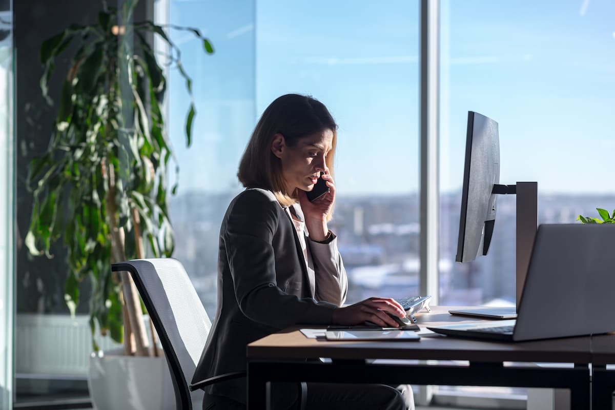 A female business women on the phone at her desk