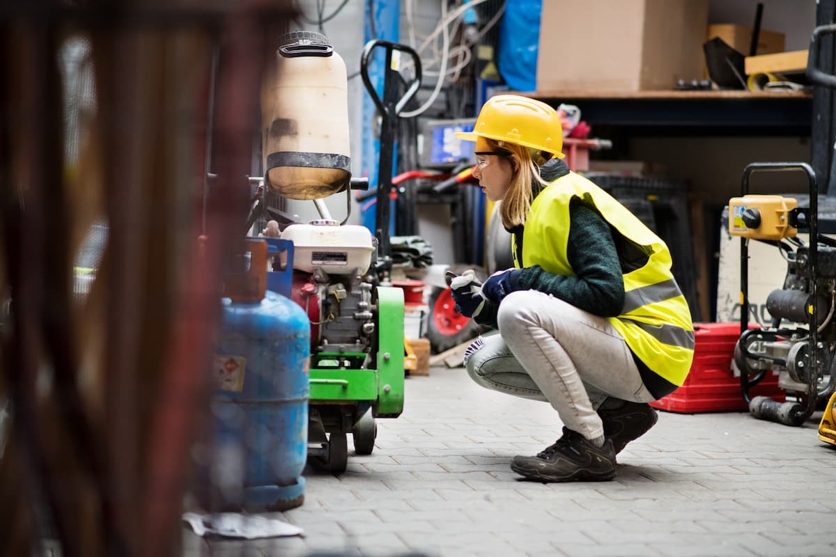 A female worker inspecting equipment in a workshop