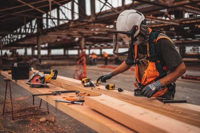 Wood worker in a large warehouse factory
