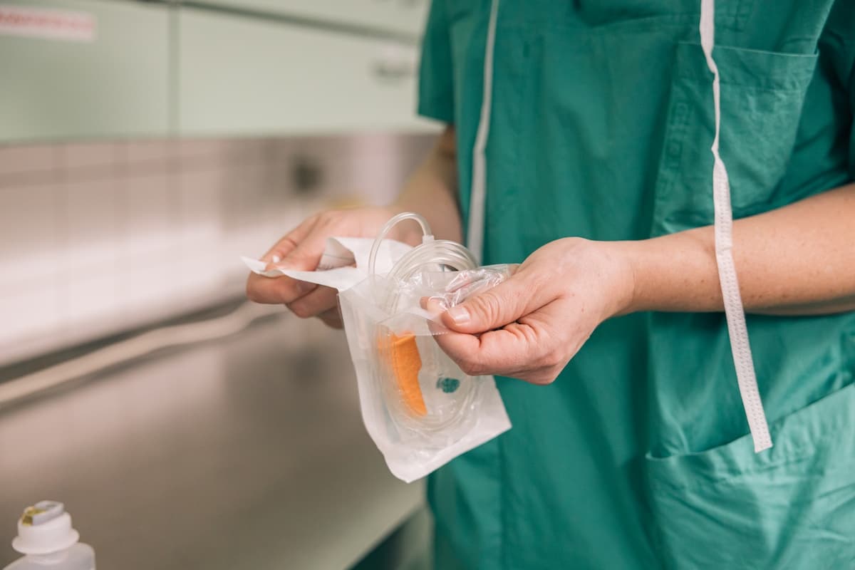 Details of a nurse handling medical equipment