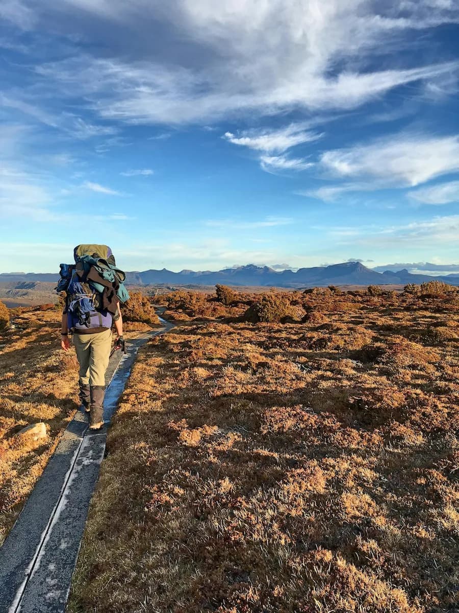 A backpacker walking in Australian outback landscape