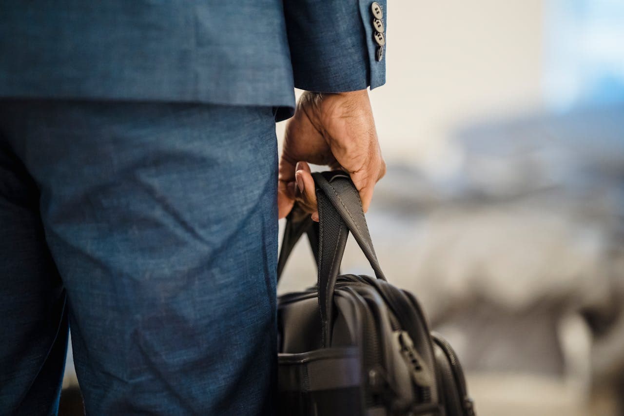Details of a business man's bag and attire
