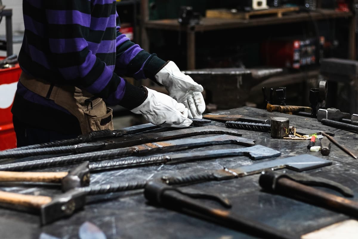 A metal worker polishing metal tools