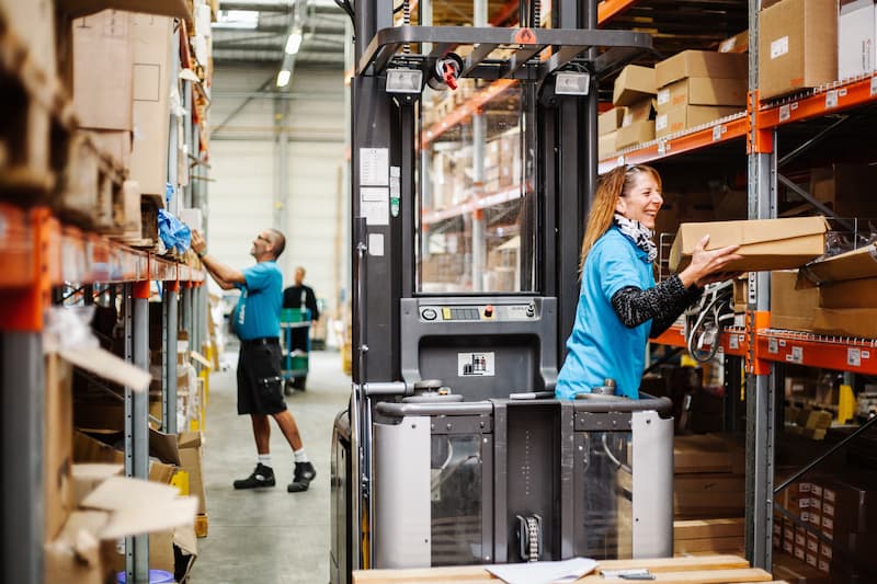 Busy and smiling warehouse workers